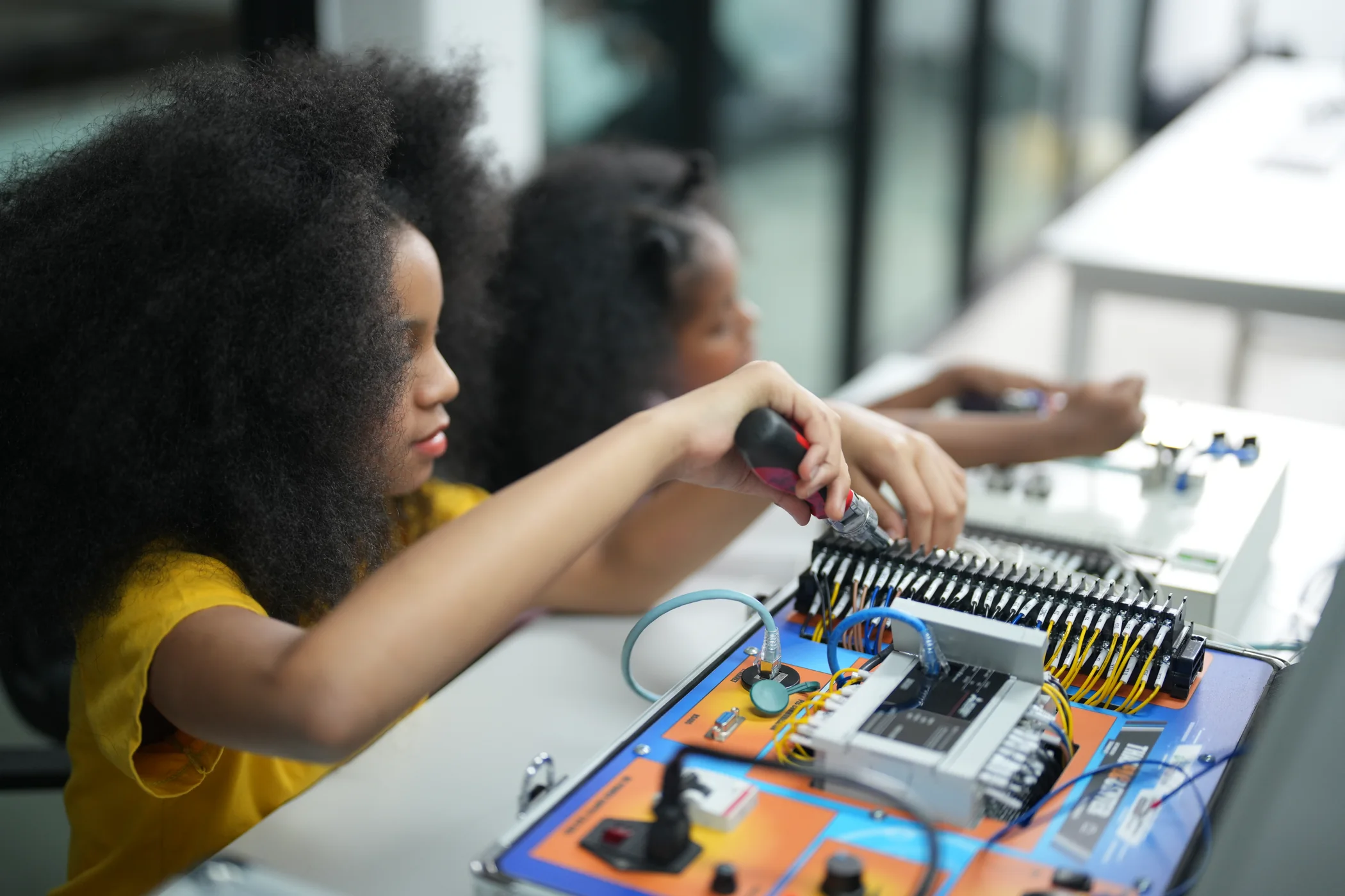 Young learners assembling an electronics control system
